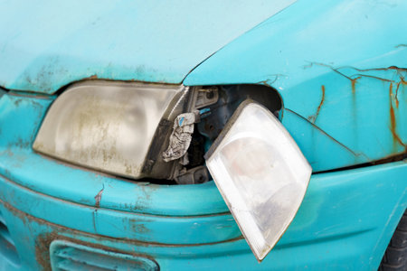 An old car with a disassembled front left headlight and a rusty fender. close-up.の写真素材