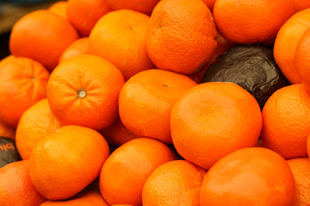 Showcase with tangerines. food market close up