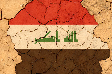 ecological concept. Drought. On dry, cracked ground is an image of the flag of Iraq.