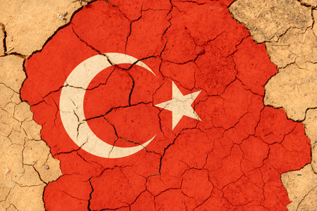 ecological concept. Drought. On dry, cracked ground, the image of the flag of Turkey.