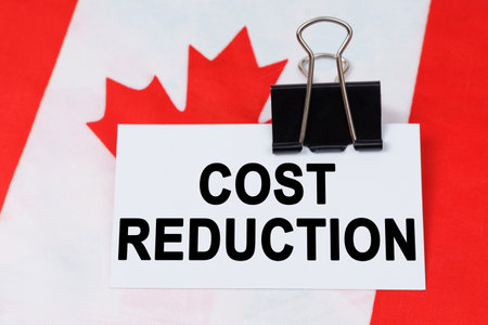 Economy and finance concept. On the flag of Canada lies a business card with the inscription - cost...