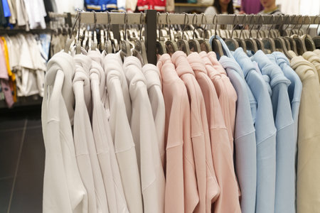 Women's sweatshirts hang on hangers in a clothing store. Close-up, background.の写真素材