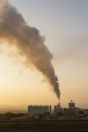 View of a high chimney with smoke ejection. Factory pipes pollute the atmosphere.の写真素材