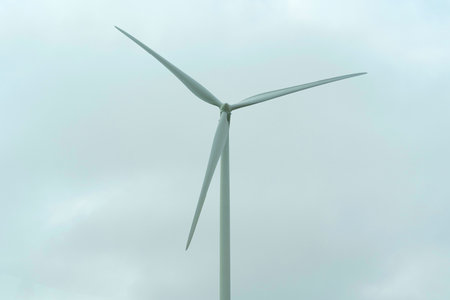 Wind turbine for power generation outdoors with sun and blue sky. Concept of alternative energy...