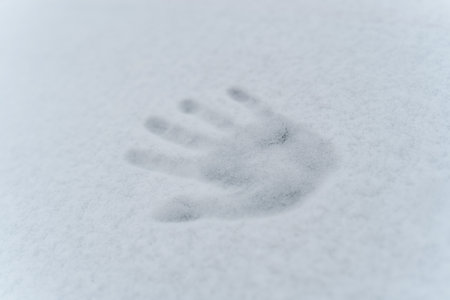 There is an imprint of the right hand in the snow. Close-up.の写真素材