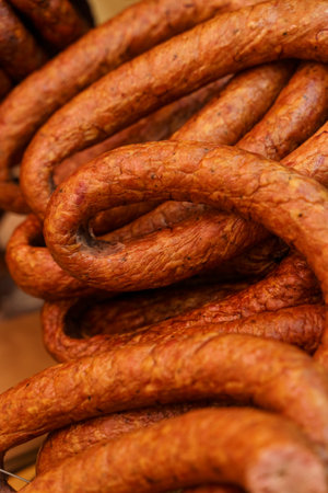 There are raw smoked sausages on the market. Close-up. Vertical frame.の写真素材
