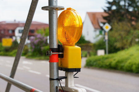 Yellow flashlight. Road repair. Warning signal at a construction site. Close-up.の写真素材
