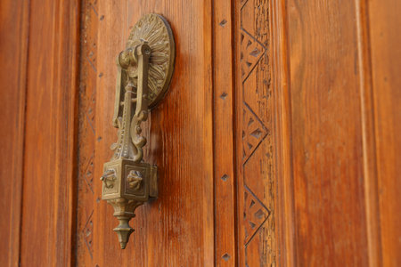Vintage old door handle on a wooden door. Selective focus.の写真素材