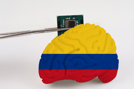 On a white background, a model of the brain with a picture of a flag - Colombia, a microcircuit, a processor, is implanted into it. Close-upの写真素材