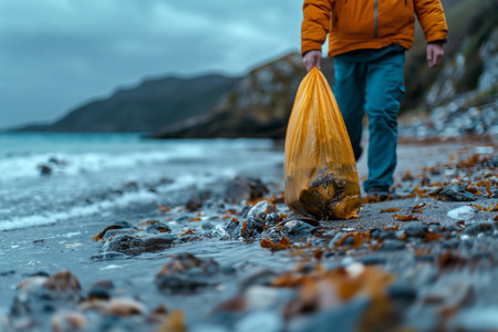 Volunteer collecting waste from sand in garbage. Ecological concept.の素材