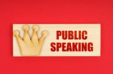 Leader concept. On a red surface there is a wooden block with the inscription - Public speakingの写真素材