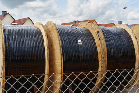 Two reels of wire are placed on the green grass.