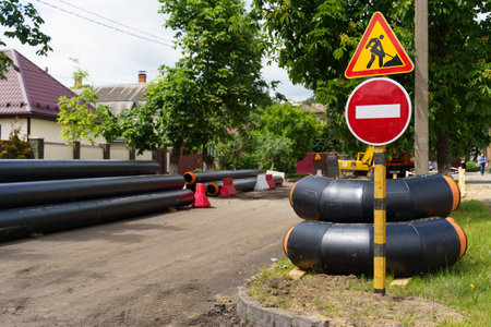 A street sign stands on the side of a rural road, providing directions to motorists and pedestrians.の写真素材