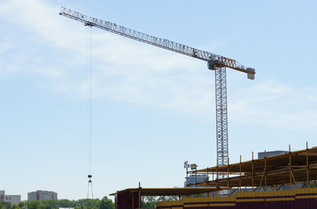 Construction cranes against the blue sky. Bottom view. Building concept.の写真素材