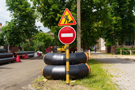 A street sign stands on the side of a rural road, providing directions to motorists and pedestrians.の写真素材