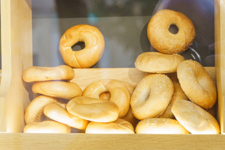 Variety of delicious donuts arranged neatly inside a rustic wooden box.
