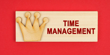 Leader concept. On a red surface there is a wooden block with the inscription - Time managementの写真素材