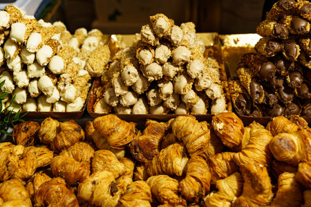 A variety of Turkish delights, featuring different flavors and nuts, are neatly arranged on a market...