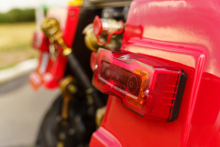 Close-up of tail light on red farm tractor.