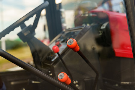 A close-up view highlighting the control levers inside the cabin of a tractor, showing the details...