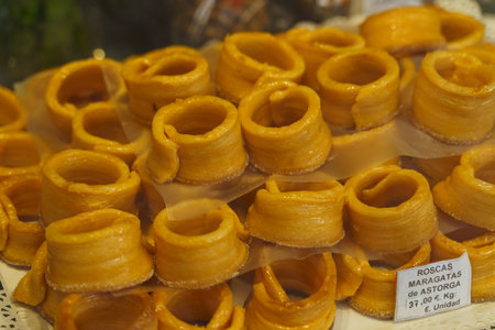 A close-up of handcrafted marzipan roses arranged neatly for sale, highlighting the delicate work...