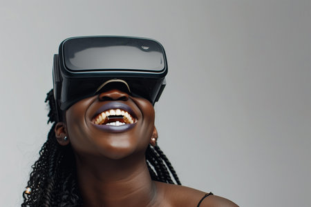 An African American woman experiences virtual reality through a headset.の素材