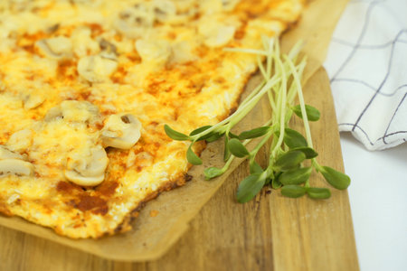 Close-up view of a plate with delicious vegetarian pizza and greens. The dish looks delicious and freshly prepared.の写真素材