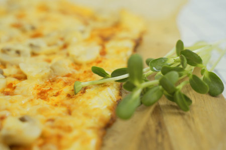 Close-up view of a plate with delicious vegetarian pizza and greens. The dish looks delicious and freshly prepared.の写真素材