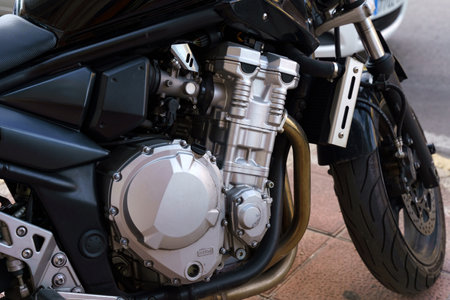 Close-up of a motorcycles engine block and exhaust pipes, showcasing the mechanical details and design.の写真素材