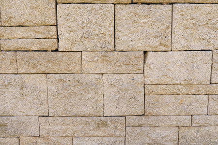 Detailed close-up of a stone wall showing its unique texture and abstract patterns.の写真素材