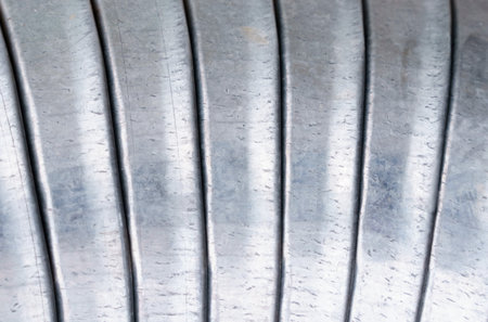 Detailed close-up view of a metal coil, showing its intricate texture and abstraction.