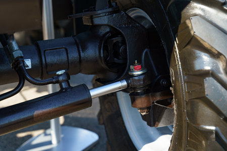 Close examination of the suspension system on a vehicle reveals various components working together. The intricacies of the parts highlight engineering excellence and functionality in motion.の写真素材