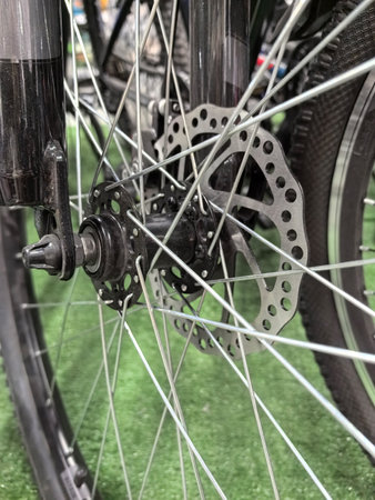 Close-up of a bicycle wheel highlighting the intricate design of spokes and discs. This particular wheel exhibits advanced braking technology suitable for mountainous terrains.の写真素材