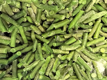 Fresh, vibrant green beans are neatly chopped and frozen, ready to be used in a variety of dishes. This convenient preparation makes meal planning effortless and nutritious.の写真素材