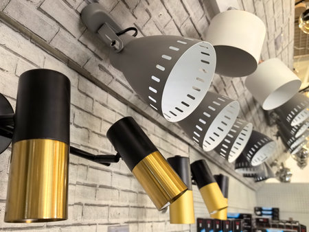Stylish lighting fixtures in various designs adorn a textured wall, showcasing a blend of colors and shapes. Perfect for enhancing interior spaces, these lamps offer both function and flair.の写真素材