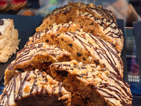 A mouthwatering selection of freshly baked goods is beautifully arranged behind glass.