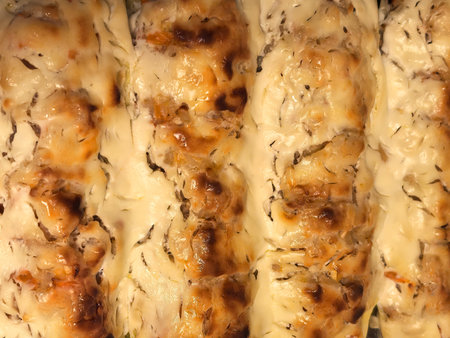 Freshly baked stuffed zucchini showcases a golden brown topping, inviting flavors of herbs and cheese. Perfectly grilled for a satisfying, nutritious dish enjoyed during a cozy family dinner.の写真素材