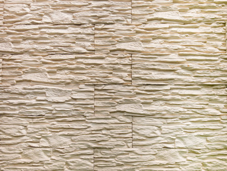 Textured decorative tiles adorn a modern interior wall, providing a chic finish to the space. Their layered design adds depth and sophistication, perfect for contemporary styling.の写真素材