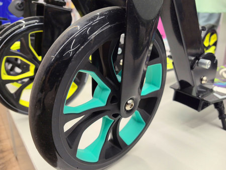 Bright wheels with turquoise accents rest on a display, highlighting contemporary design elements....