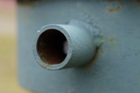 Close up of a weathered metallic pipe revealing its rustic surface and structure. This view...