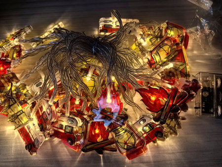 Colorful string lights shaped like fire trucks and flames illuminate a cozy space. Perfect for a...