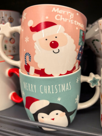 Bright and festive mugs showcase Santa Claus and a friendly penguin, spreading holiday cheer. Perfect for seasonal gatherings, these cups add warmth to Christmas celebrations and fun to hot drinks.の写真素材