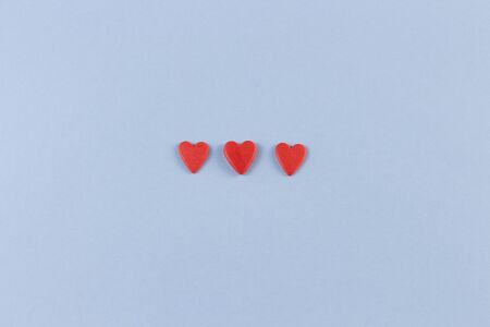 Happy valentines day. Beautiful wallpaper card with three red hearts in the center on a blue...