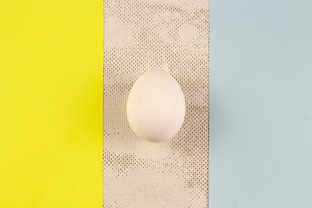 one white chicken egg on a wooden background. place for text, easter holiday concept.