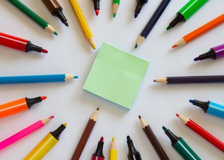 Multi-colored markers and pencils on a white background top view. School supplies.copyspace for text.の写真素材