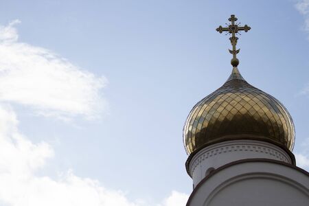 Golden dome of an orthodox temple against a cloudy sky. copyspace for textの写真素材