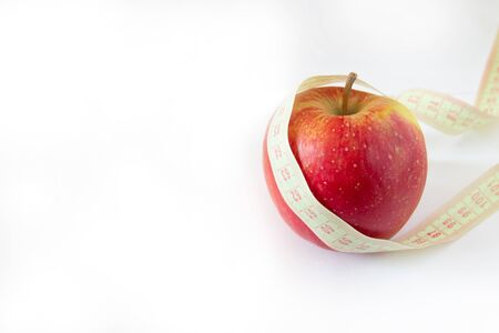 Red apple and tape measure isolated on white, copyspace for text.の写真素材