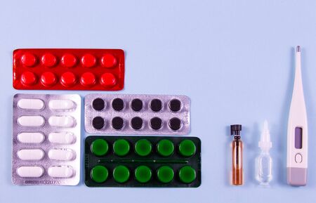 White green black and red pills in blister packs. Glass bulb and plastic bulb, electronic...