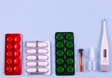 White green black and red pills in blister packs. Glass bulb and plastic bulb, electronic...
