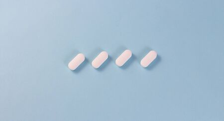 White pills on a blue background in the center. Copy for text